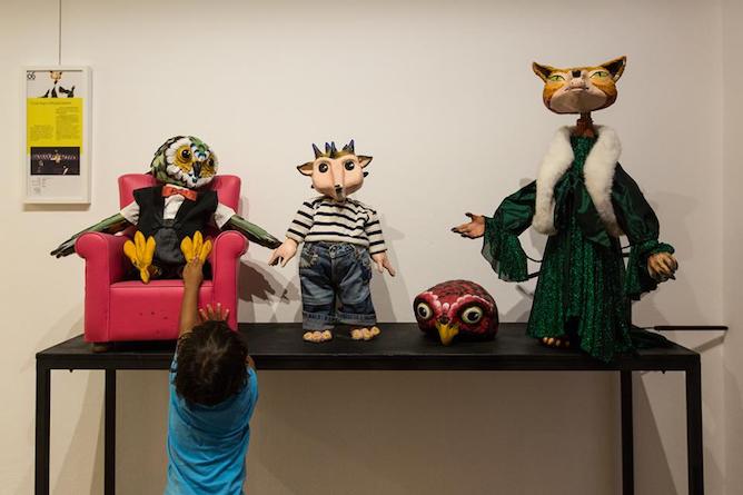 children touching real sized puppets